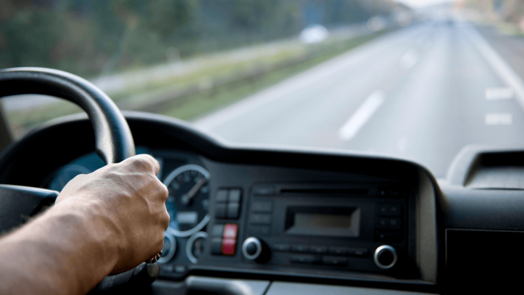 Hand on the steering wheel of a truck 